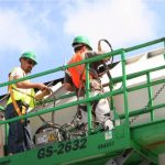 Commercial painting by 2 workers on a forklift